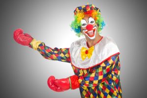 Clown with boxing gloves isolated on white